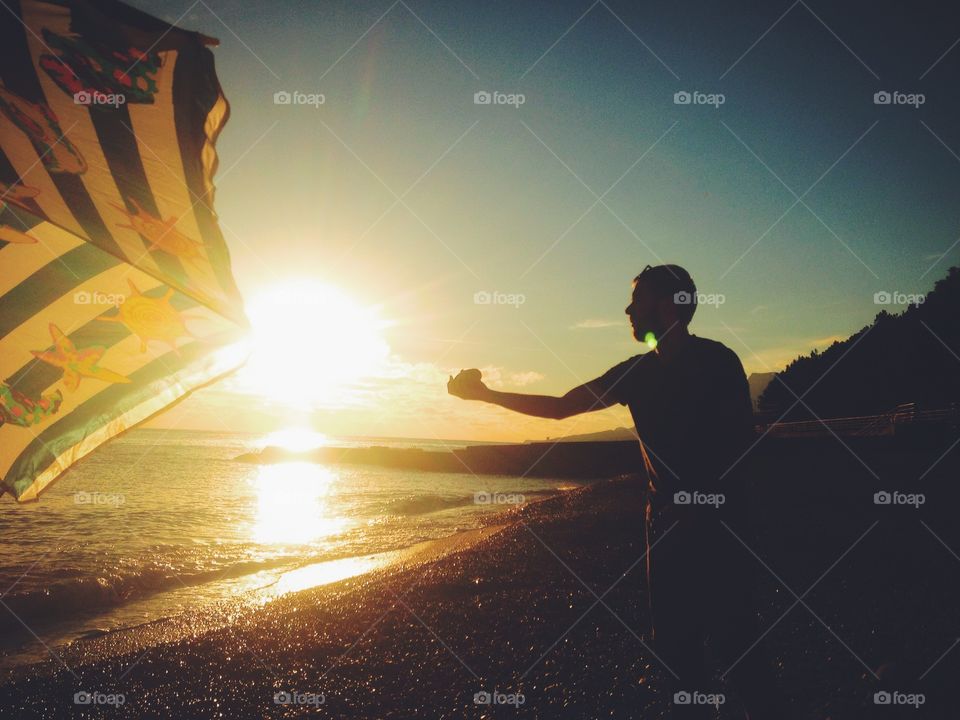 Man catching the sun at the seaside 