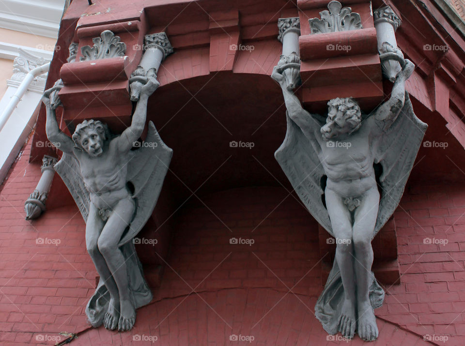 Gargoyles in Kiev. Old red building with gargoyles over the entrance