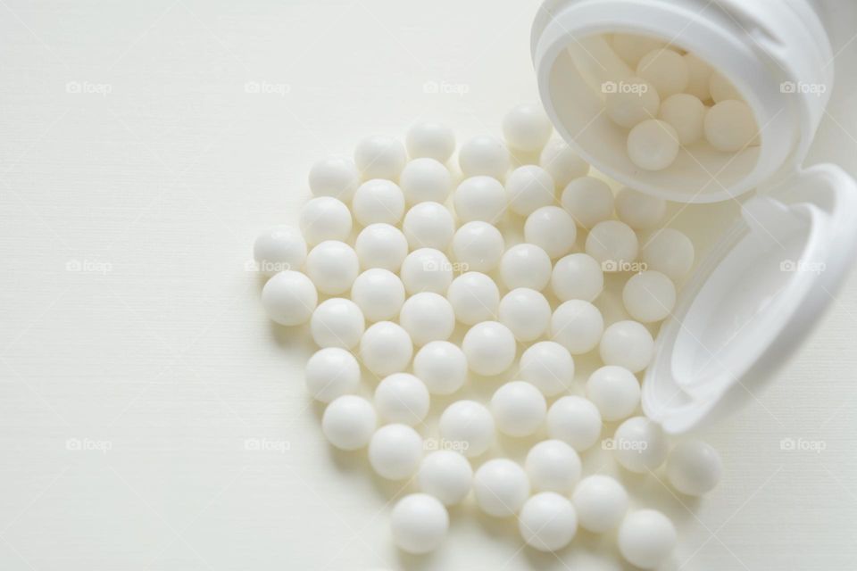 white vitamins on a white background, healthy lifestyle