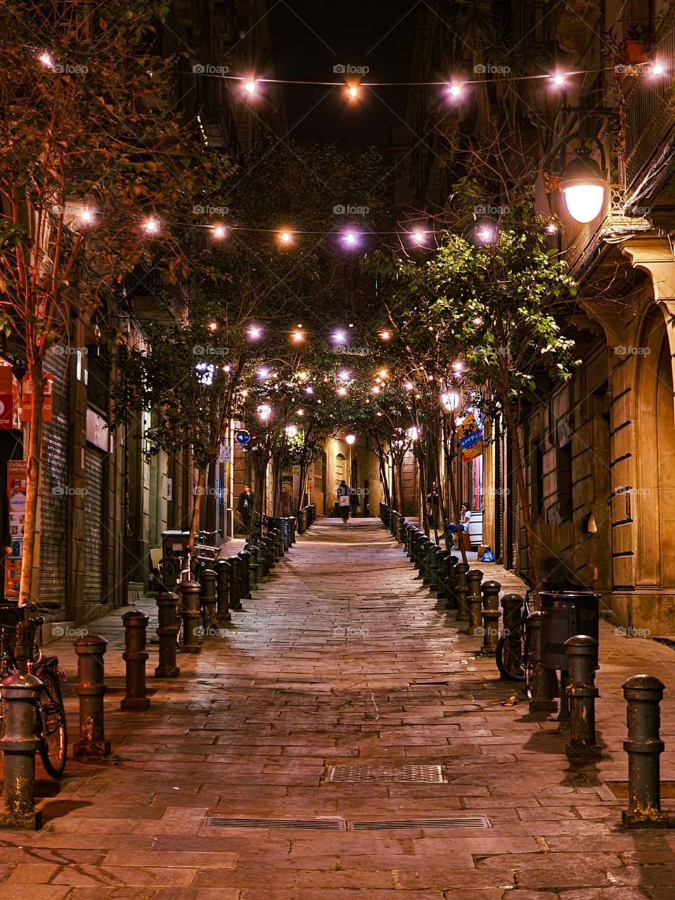 A side street in Barcelona, Spain. Street full of small decorative lights