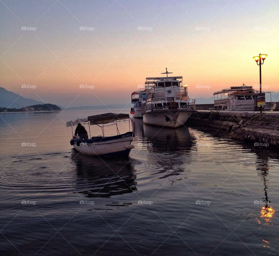 Boat in sea during sunset