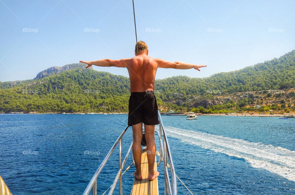 Rear view of man standing in ship