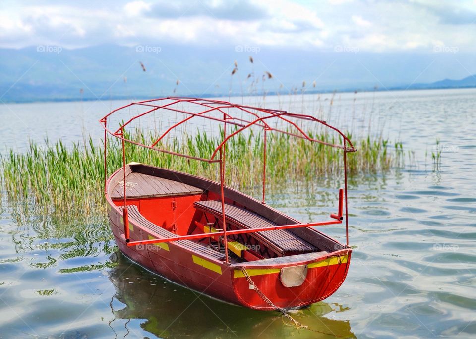 A red boat in the calm waters of Dojran lake