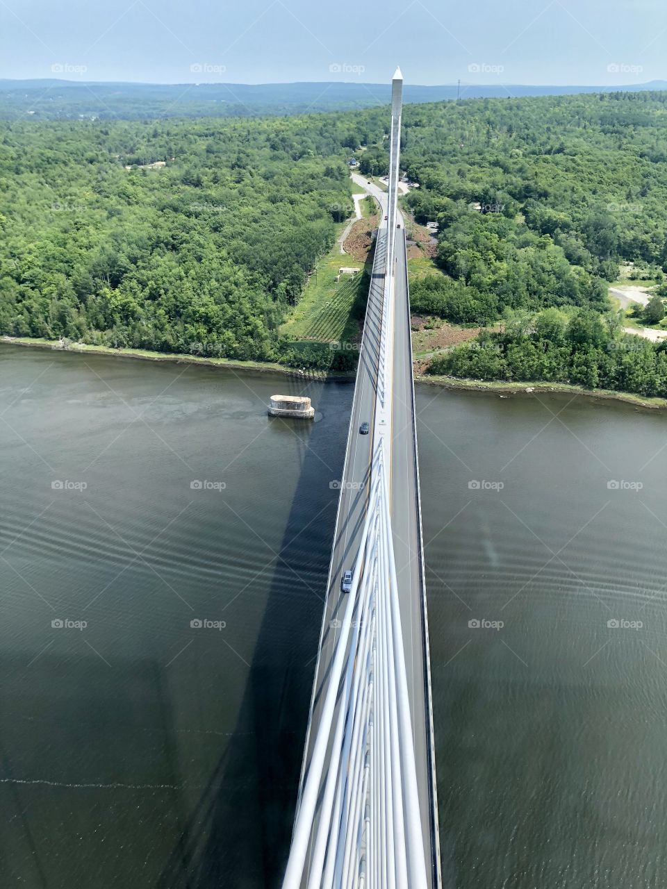 Aerial view of Penobscot Bay and Bridge and a forested landscape of greenery, shot from top of Penobscot Narrows Bridge Tower Observatory, the tallest in the world of its kind. 