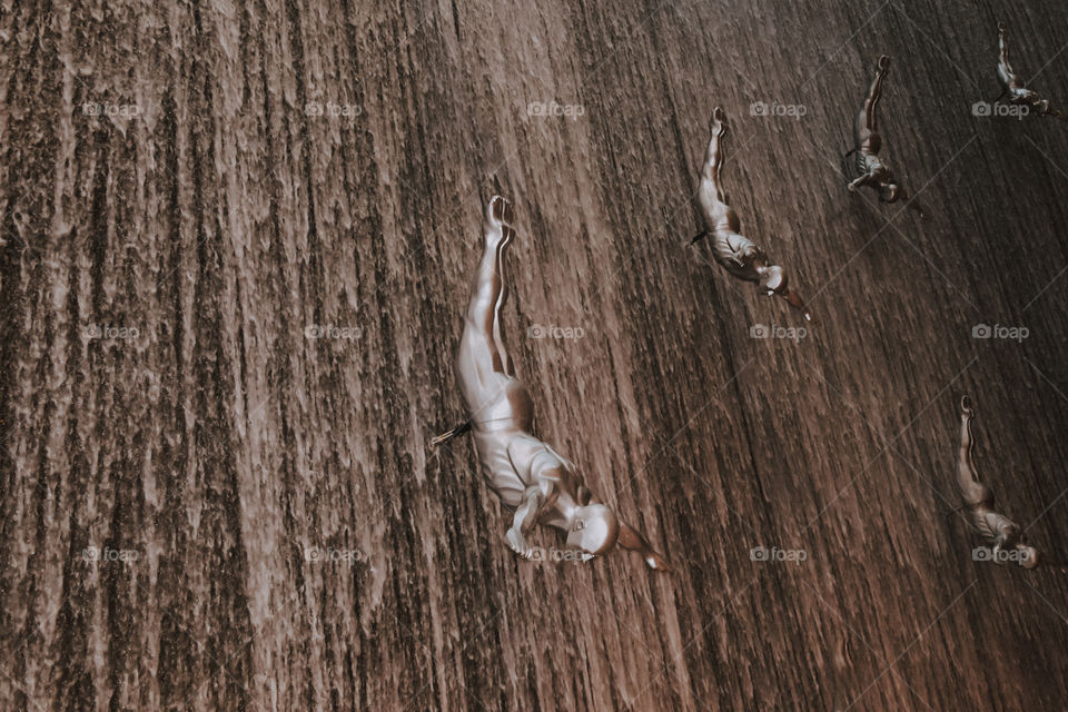 A group of adventurous athletic young adult men falling down. Abstract pattern texture frame background concept.