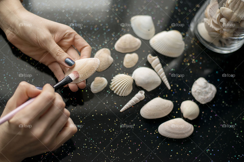 Woman coloring a sea shell
