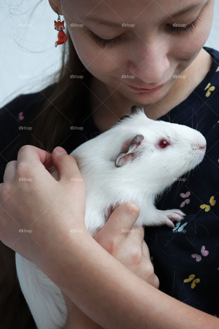 Child holding their guinea pig