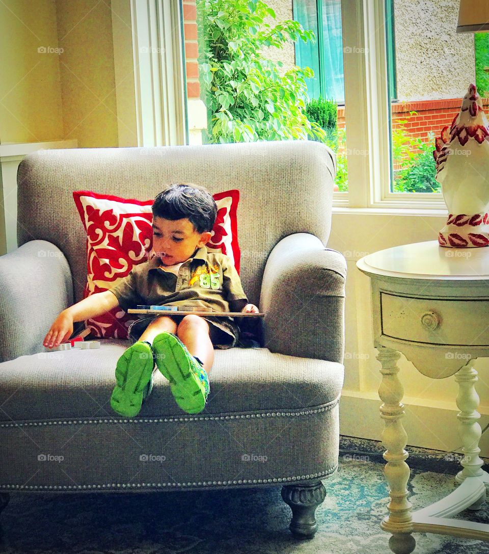 Little boy enjoying a quiet book nook