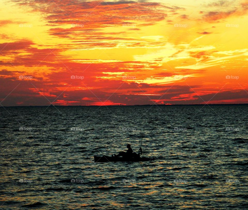 Fisherman fishing by the sunset 