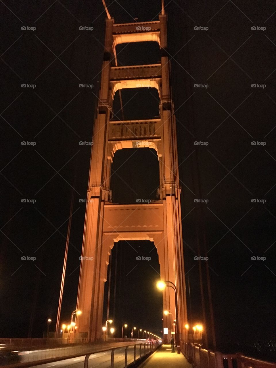 California landmark Golden Gate Bridge close up in San Francisco, lit up at night