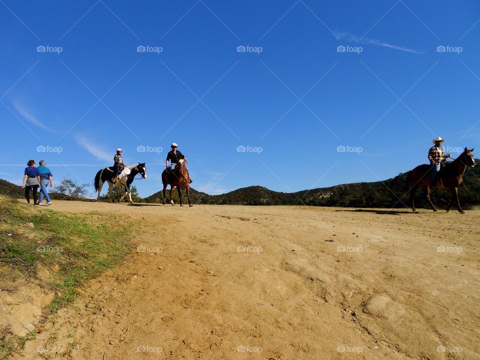 People hiking. Walking and horseback riding