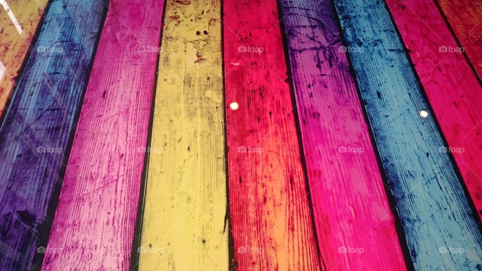 Multicoloured coffee table made with wooden planks and glass cover, at Point Clear, St Osyth, Essex. Captured on a winter trip to Clacton.