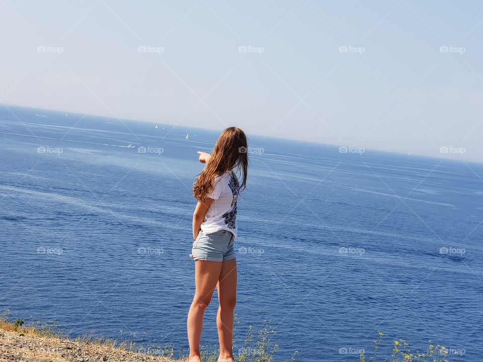 Girl looking out at great view over ocean