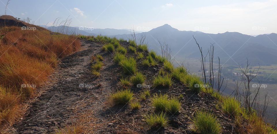 walking, tourism, knowing the mountains of beautiful color and splendid beauty.  brown, sky blue