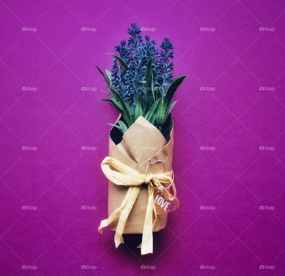Present of love of purple lilacs on a purple background.