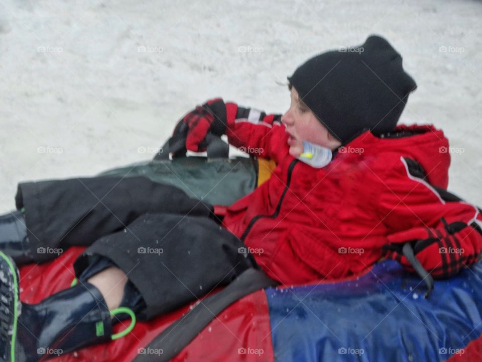 Boy On A Sled In Winter