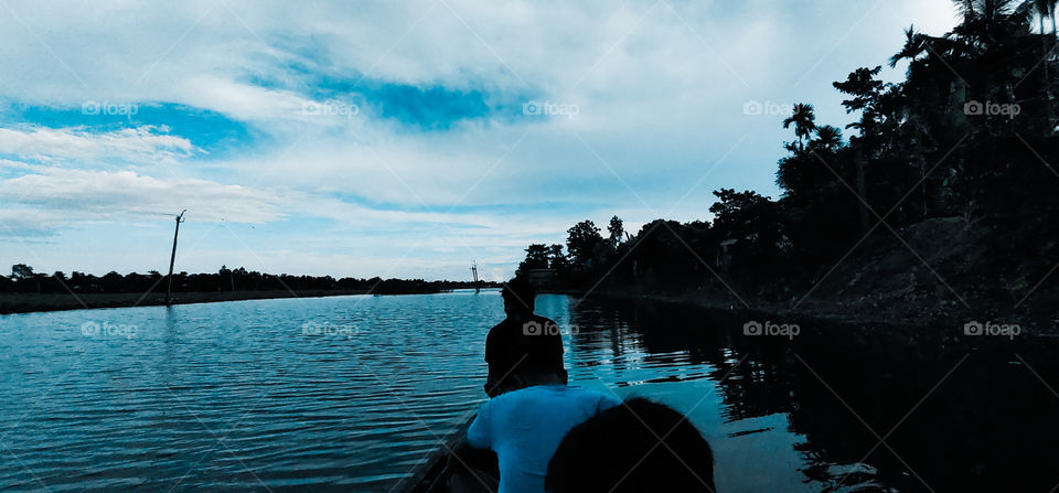 A regular summer evening of a village... blooming their summer mood in a boat in the middle of river🌅