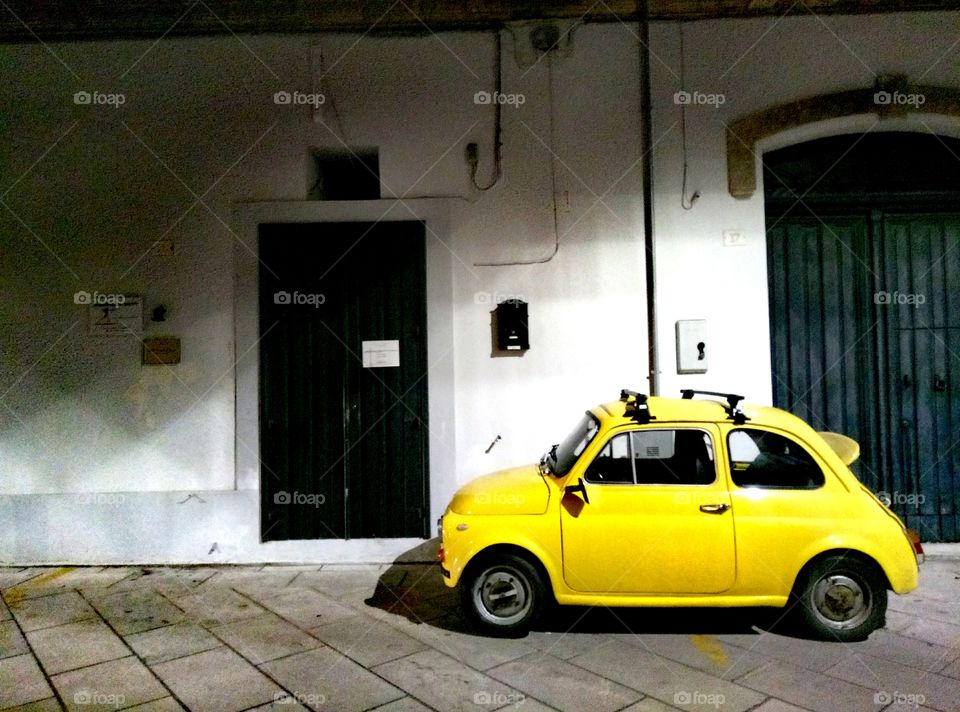 Cute little yellow car in Presicce, Italy.