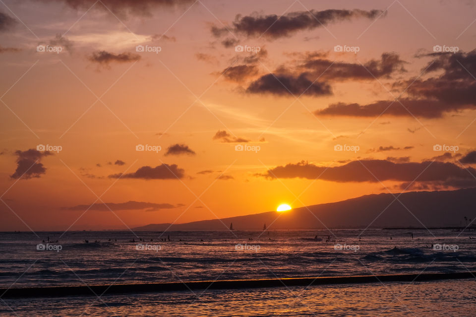 Warm, colorful sunset at Waikiki Beach, HI