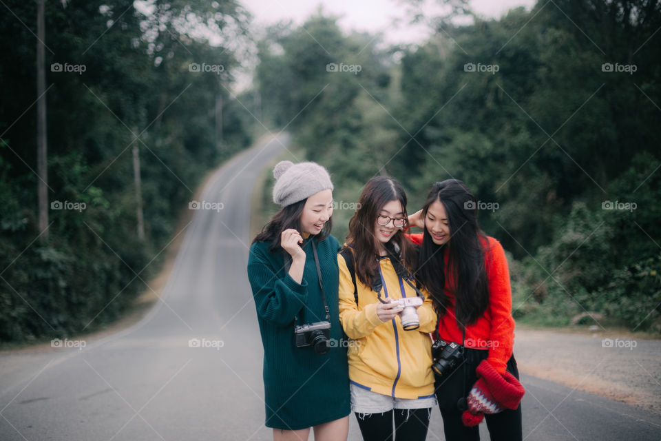 Asian Tourist looking at the camera on the road 