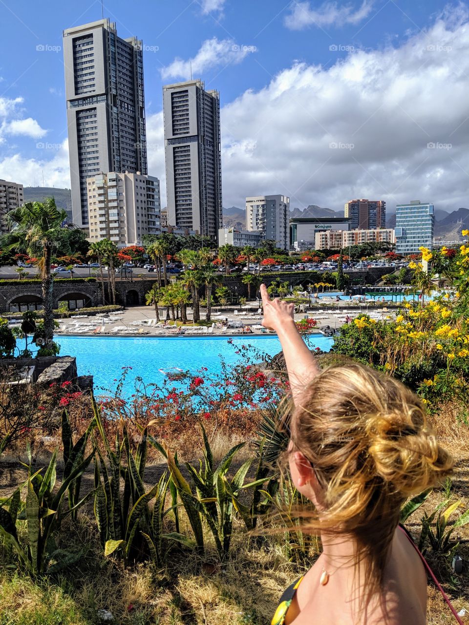 Woman is pointing out on a skyscrapers
