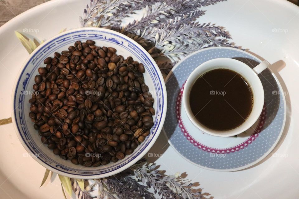 A cup of coffee and coffee beans