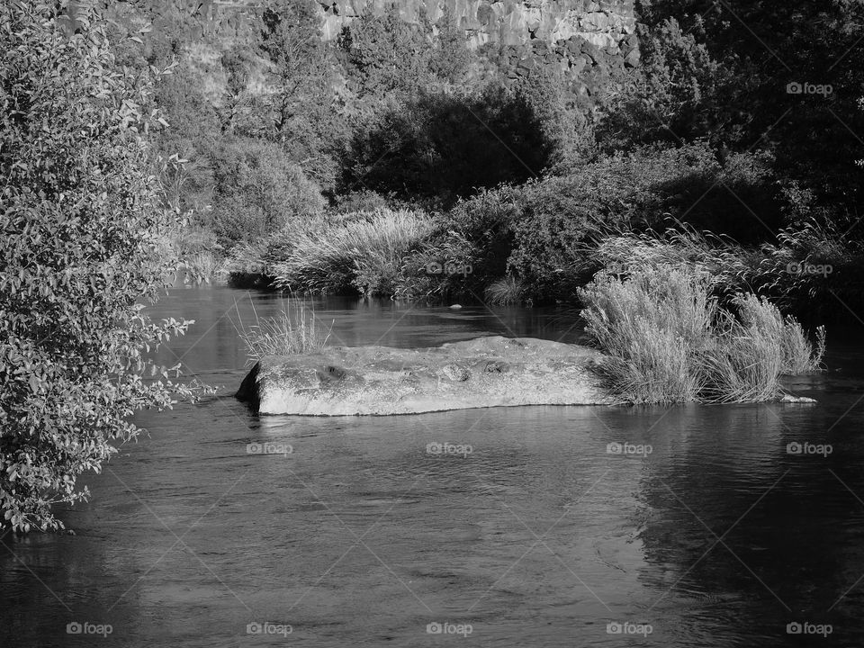 The serene Deschutes River in Central Oregon on a sunny summer day. 