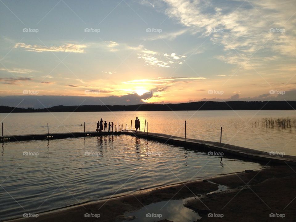 Silhouette of people at beach during sunset