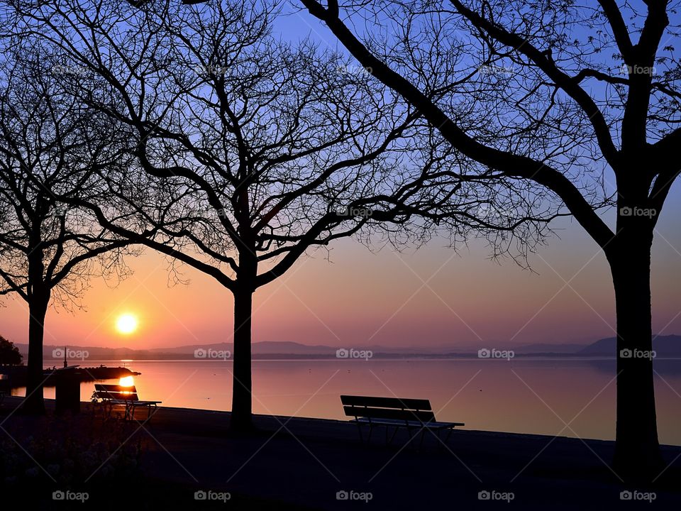 Silhouette of empty bench during sunset