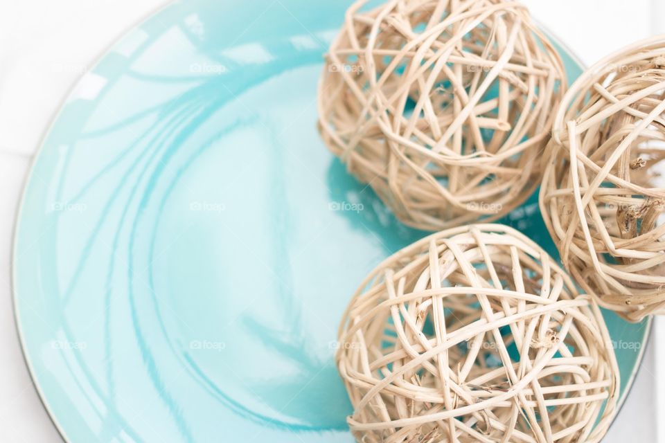 Three Woven Willow balls. Three woven willow balls on blue plate 