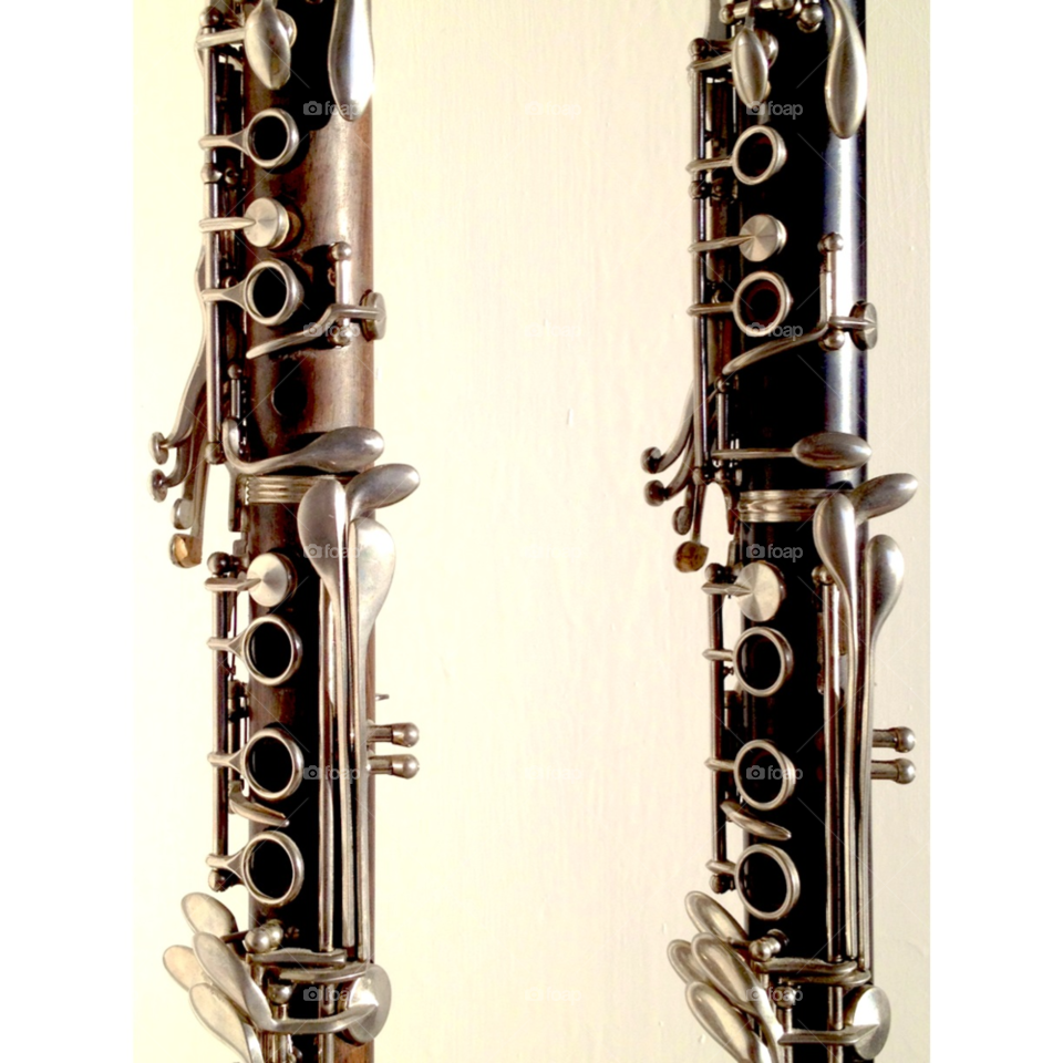 Two clarinettes. Plain photo of two standing clarinettes