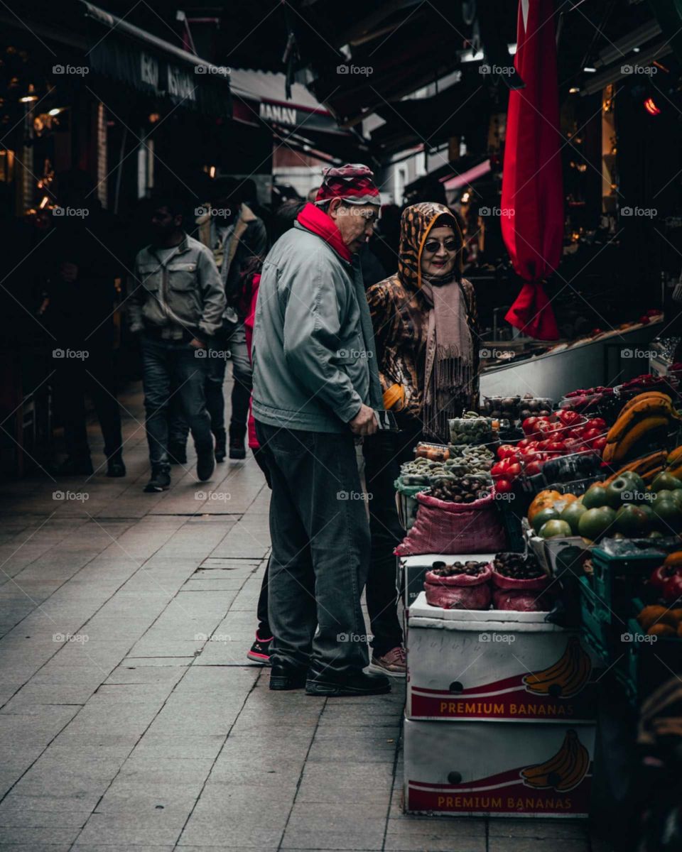man buying fruits in market