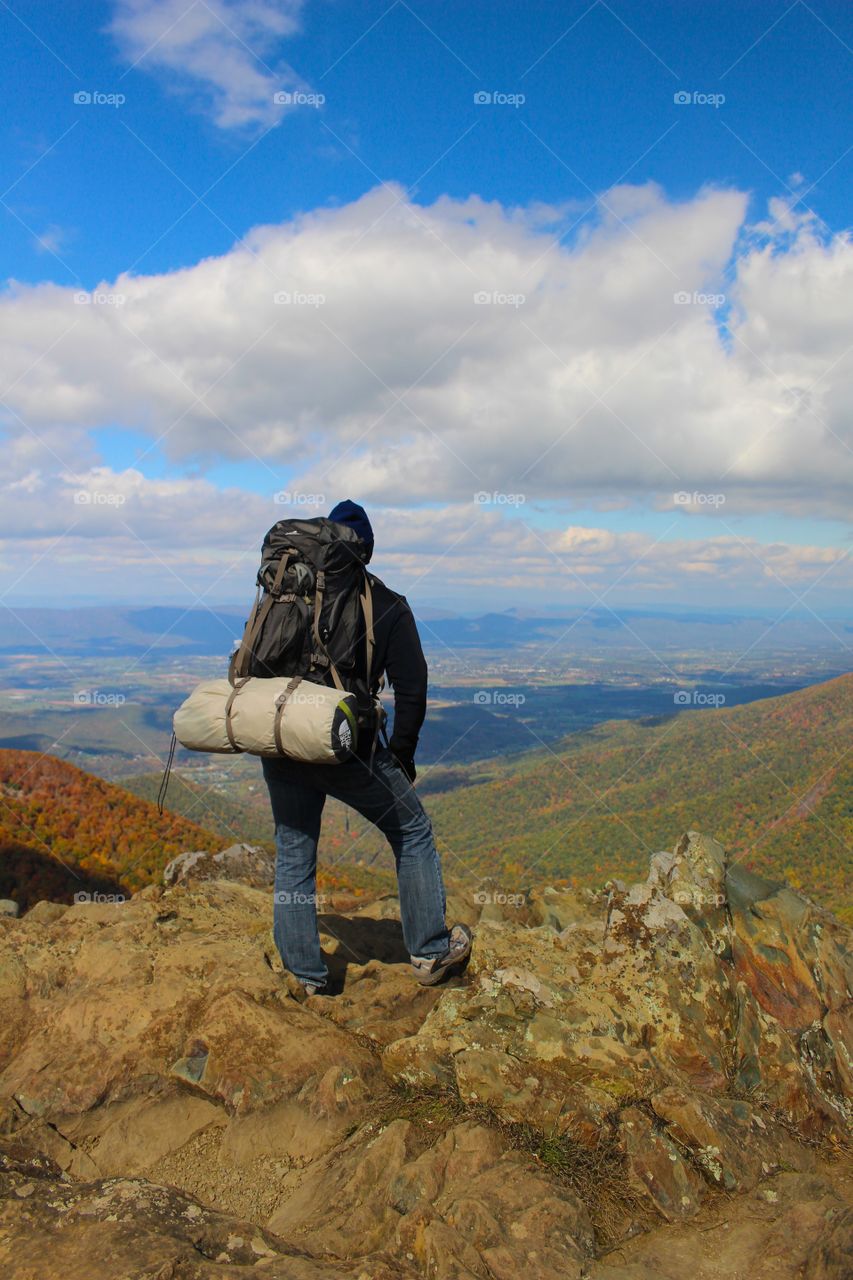 Backpacker looking out over the valley.