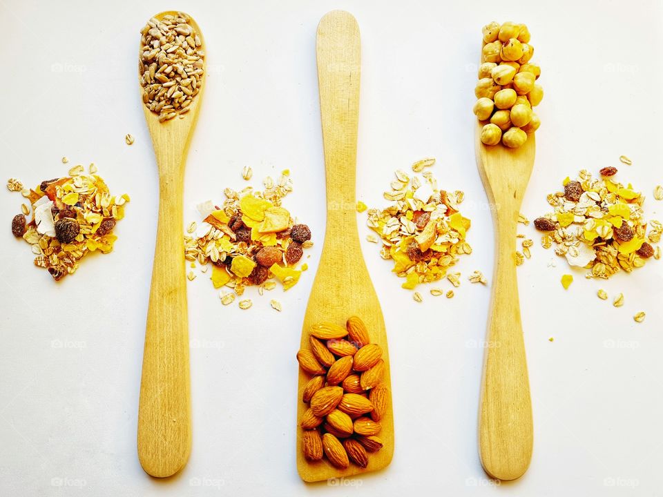 wooden ladles containing healthy nuts and seeds