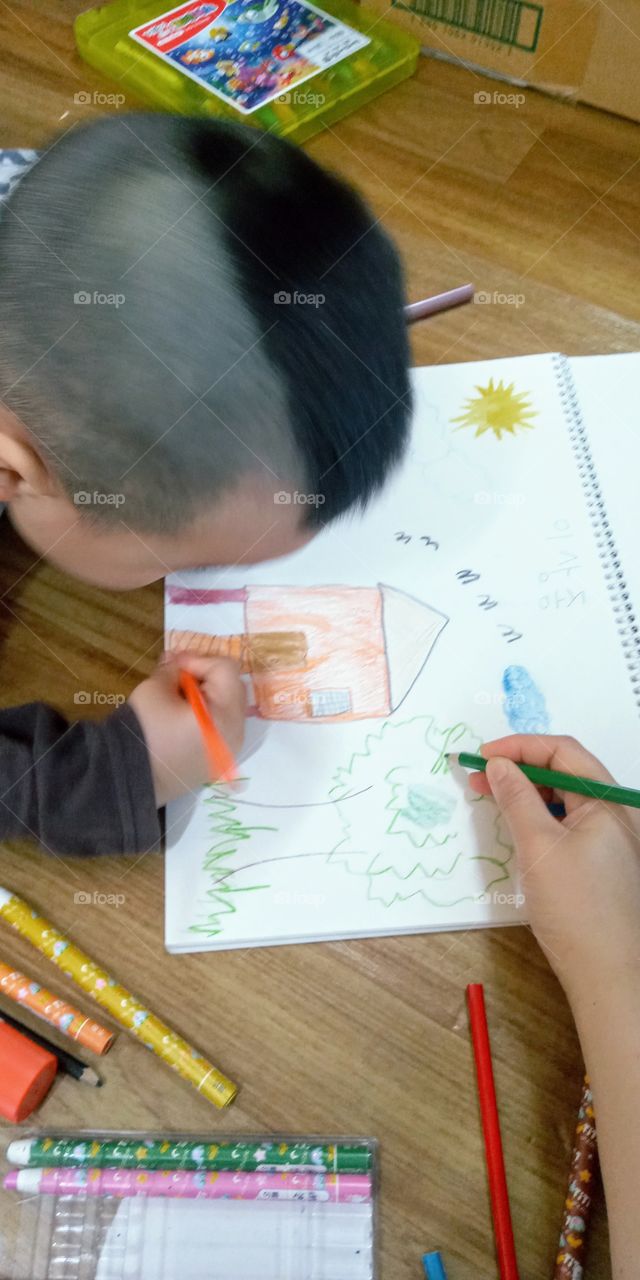 helping each other in colouring his drawings.