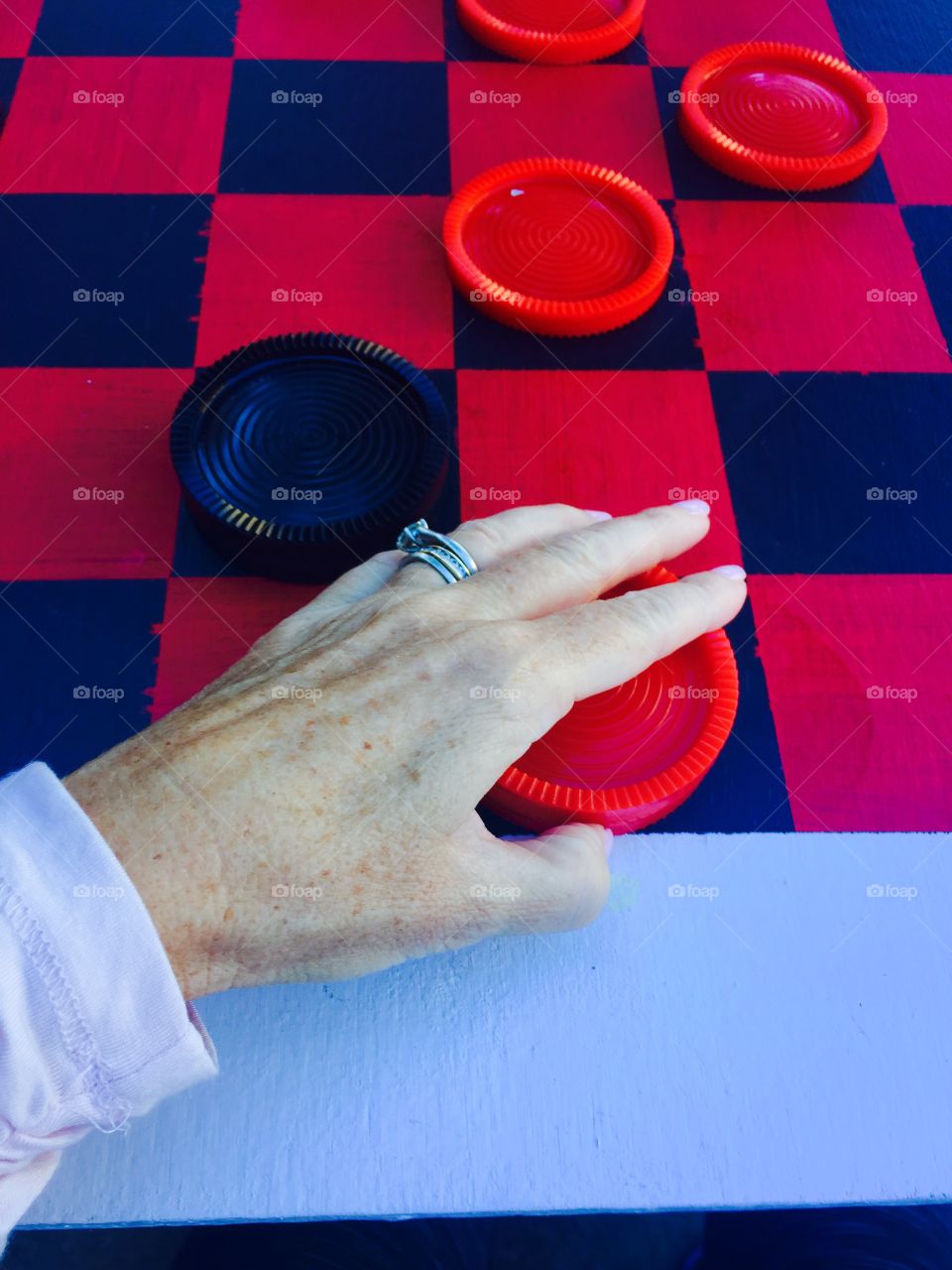 Large checker board - aging woman hand 