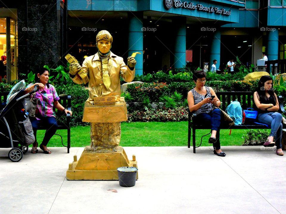 a mime and tourists in eastwood in libis, quezon city, philippines