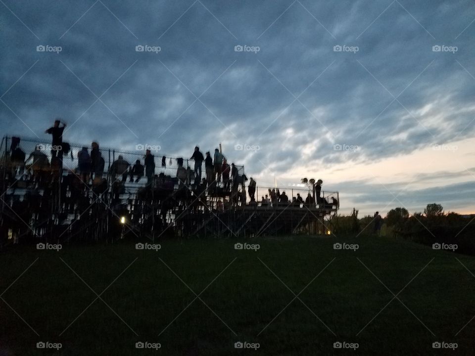 race fans, spectators, bleachers, audience, summer night