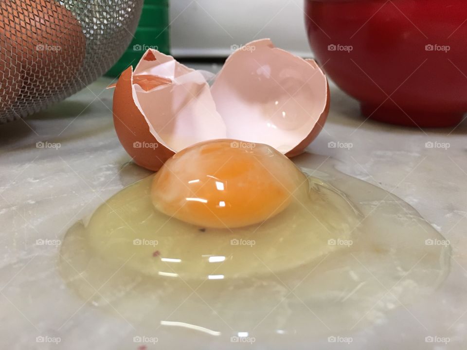 Closeup of task cracked egg on counter top