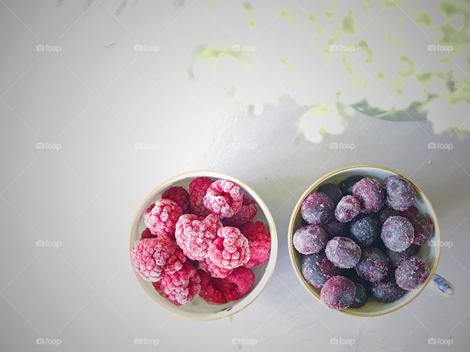 Raspberries and blueberries from a top perspective 