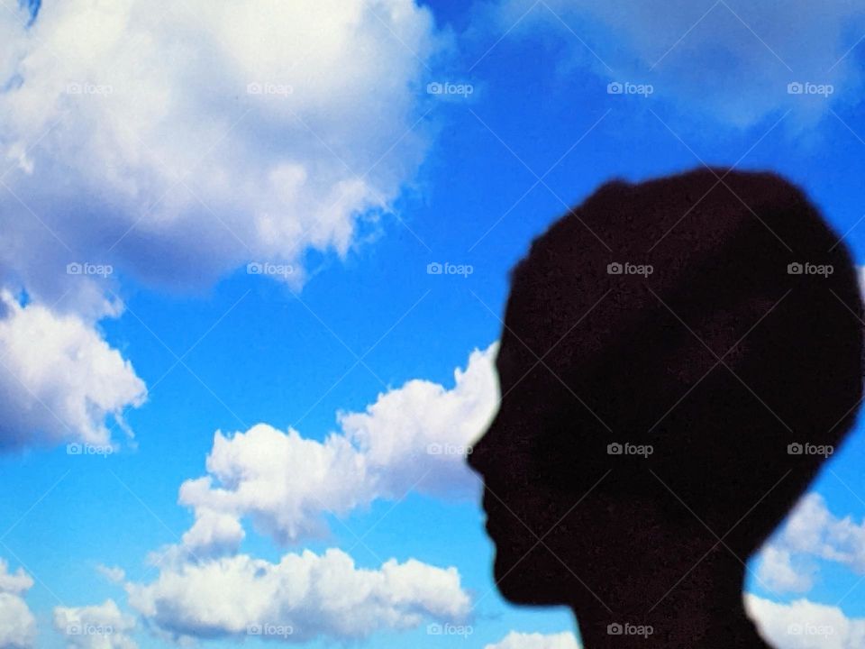 Boy profile with cloud background