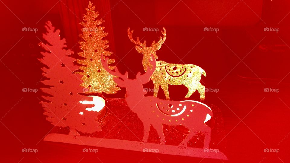 red gold christmas decoration with reindeer and tree