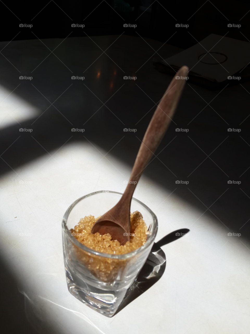 brown sugar. wooden spoon in small glass