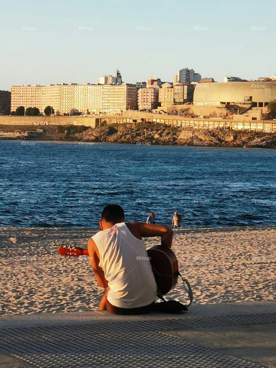 The sun is in the beach and the Spanish guitar men