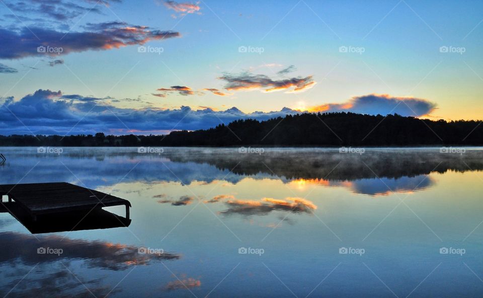 bright sunrise at the lakeside in polish countryside