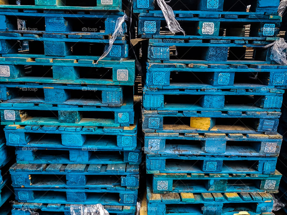 Stacked blue wooden pallettes