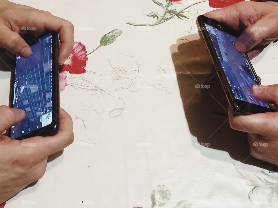 People gaming PUGB with smartphones