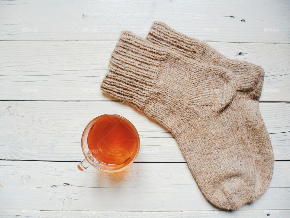 woolen socks and a cup of hot tea