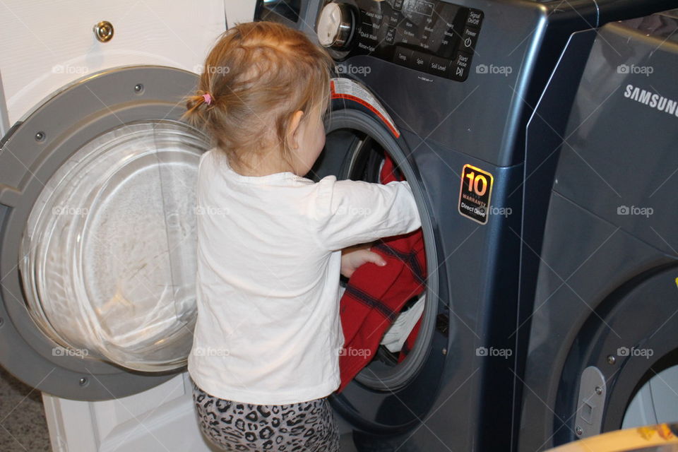 Child helping with laundry