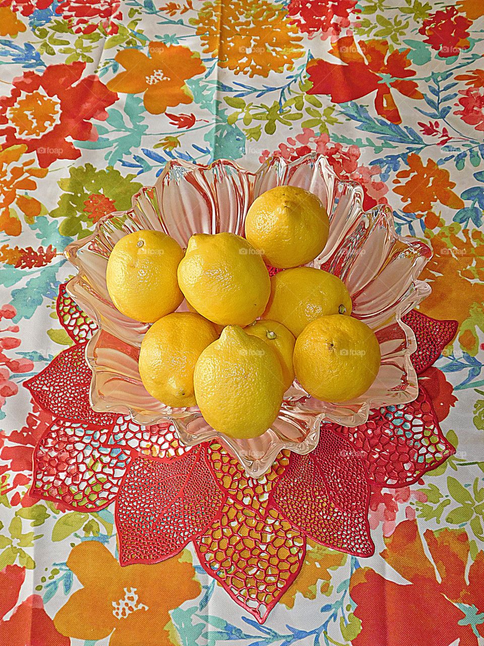 Fruit - Lemons displayed in a vertical position in a bowl on top of a decorative table cloth